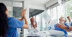 Doctor, team and applause in celebration for victory, win or medical achievement in teamwork at the hospital. Happy doctors clapping and celebrating healthcare procedure, success or growth at clinic