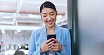 Business woman, phone and typing in office on social media, internet browsing or texting. Tech, mobile and happy female from Japan on break with smartphone for messaging, web scrolling or networking.
