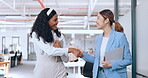 Business women, handshake and welcome, introduction and hello to new intern while walking in office. Happy, excited and diversity workers shaking hands for support, teamwork or onboarding partnership