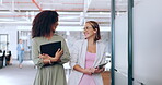 Creative business woman, tablet and walking in discussion, laughing or joke together at office. Happy women employee designers having a walk for social or funny conversation in startup at workplace