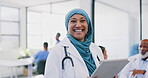Tablet, healthcare and happy muslim woman doctor in hospital for telehealth, medical research or management in Indonesia . Portrait of smile surgeon in hijab, digital technology or clinic information