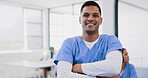 Face, healthcare and insurance with a nurse man standing arms crossed in a hospital for medical treatment. Portrait, doctor and trust with a male medicine professional in a clinic for diagnosis