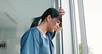 Mental health, stress and depressed doctor at window in China, burnout and headache from late surgery. Anxiety, depression and woman in medical field or healthcare professional overworked and tired.