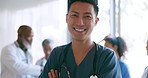 Doctor, face smile and Asian man in hospital for healthcare support, employee confidence and medical mindset motivation. Nurse, happiness portrait and standing crossed arms in clinic for trust vision