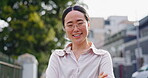 Face, vision and mindset with a business asian woman standing arms crossed outdoor in the city alone. Portrait, glasses and confidence with a female employee looking positive outside in an urban town