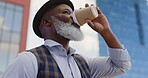 Black senior businessman, coffee and standing city for morning routine, positive mindset vision and remote travel for work. African man, drinking tea and thinking outdoor in New York for traveling