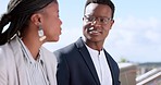 Business, black woman and black man relax on rooftop talking or speaking of jokes or goals in city building. Comic, comedy or happy employees enjoy bonding on work break or planning a group project