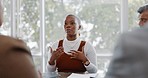 Meeting, discussion and professional black woman talking to her colleagues in the office conference room. Teamwork, presentation and African female employee in conversation with her team for project.