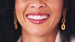 Oral hygiene, closeup of a woman smiling and showing her perfect white teeth. Confident young black woman with a bright and beautiful smile. Visit your dentist regularly for dental cleaning