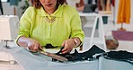 Fashion designer, scissors and hands with fabric in clothing manufacturing factory. Woman, seamstress and dressmaker with textile material, tailor and production for creative sewing in small business