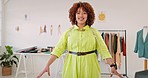 Creative woman, fashion designer and face of tailor standing by work desk with smile for startup. Portrait of happy confident female manager smiling in clothing, fabric or garment in studio workshop