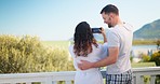 Couple, vacation and phone photography with mountain, lake and romantic honeymoon with hug in morning. Man, woman and smartphone for nature, social network and freedom with love on outdoor holiday