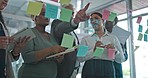 Collaboration, brainstorming and team at presentation, ideas for teamwork at startup and sticky note on glass wall. Strategy, planning and analytics in meeting at idea workshop for agency employees.