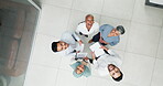 Collaboration, overhead and huddle with a business team laughing while working together in an office. Face, teamwork and documents with a man and woman employee group standing in a circle from above