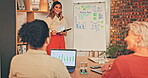 Business woman, tablet and writing on whiteboard for coaching, planning or brainstorming in team meeting. Female coach or mentor training staff with touchscreen, graph or chart for sales statistics