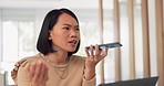 Asian woman, frustrated and phone call discussion in office for online business communication, employee stress and anxiety. Angry female, smartphone call and upset boss for online networking conflict