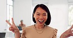 Happy, goofy and face of a business woman in the office with a love, peace and heart hand gesture. Happiness, fun and portrait of a professional female employee from Asia with signs in the workplace.
