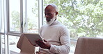Tablet, waiting and interview with a senior black man sitting on a chair in line for recruitment or hiring process. Business, working and job interview with a mature male seating at human resources 