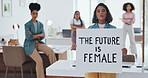Equality, empowerment and female leader holding a sign in the office with her business woman group at work. Future, human rights and diversity with a feminism team working for revolution or change