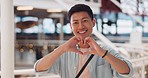 Shopping, hands in heart and face of Asian man with smile for shopping, retail and consumerism. Lifestyle, commerce and male enjoying weekend at shopping mall in Tokyo for sale, discount and bargain