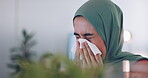 Muslim, nose tissue and woman sick with flu, cold or covid virus infection while working on computer. Medical healthcare, blowing into napkin and Arab Islamic worker ill from winter allergy sickness