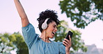 Music, phone and headphones, woman in park happy and excited while dancing in garden trees. Technology, smartphone and dance, happy woman enjoying streaming service or free internet radio station.