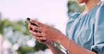 Hands, phone and woman in park for typing, social media and communication on internet in summer. Girl, smartphone and chat on web app, social network and mobile digital tech on urban adventure