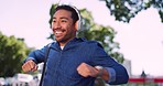 Asian man dance, headphone and smartphone for music, outdoor and casual. Male, guy and headset to listen to radio, relax and wellness for balance, streaming and online song for celebration and energy