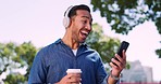 Man in street, smartphone and headphones, excited about notification, success in news on social media with music, technology and communication. Coffee, travel and happy in city, reading and streaming