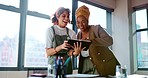 Digital tablet, women and marketing team doing creative research for a project in their office. Collaboration, teamwork and female business partners checking their company website on a mobile device.