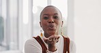 Blowing kiss, happy and face of a black woman with carefree energy, happiness and crazy at work. Playful, smile and portrait of a cute African employee with confidence to show love at the workplace