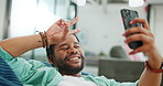 Black man, phone and peace sign on video call with smile for social, networking or communication at the office. African American man relaxing on break talking on smartphone videocall at the workplace