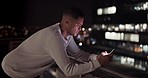 Business man, phone and night data while online on an urban building rooftop typing email, search or communication for networking on trading app. Entrepreneur on terrace in dark with 5g network