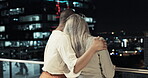 Back, support and trust with a business woman consoling a colleague on an office balcony at night. Empathy, help and love with a female employee comforting a coworker during a dark evening at work