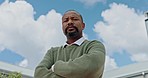 Power, serious and face of a black man with arms crossed on a blue sky in the city of Morocco. Vision, success and portrait of an African businessman with arms folded for executive confidence