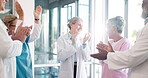 Doctor, nurse and team applause in celebration for healthcare achievement, goal or promotion at hospital. Group of medical professional clapping and celebrating teamwork, unity or victory at clinic