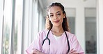 Face, doctor and black woman with smile, healthcare and wellness in hospital, arms crossed and confident. Portrait, African American female and medical professional in uniform, happy and leadership