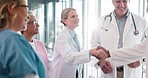 Handshake, congratulations and healthcare, woman and black man shaking hands or applause for good job in medicine. Doctors, thank you and welcome to new recruit or partner at hospital with hand shake