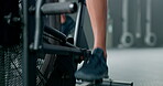 Fitness, legs and feet in cycling at gym on stationary bike for healthy cardio workout, exercise or training. Leg and foot of sporty athlete riding or exercising on bicycle equipment at the gymnasium