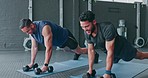 Fitness, gym and friends planking with dumbbell together for arm and stomach muscle training on floor. Exercise, health and body care, man and personal trainer workout with kettlebell at sports club.