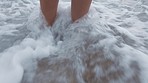 Beach waves, feet and freedom of a woman taking time to relax, travel and enjoy the water. ocean, tourism and recreation with a barefoot female on a holiday or vacation for peace, calm and quiet