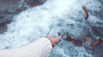 Hands, relax and water with a woman moving her hand at the beach against an ocean or sea background. Waves, current and tide with a female feeling free and at peace on the shore or coast alone