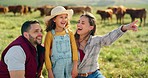 Happy family bonding on a cattle farm, happy, laughing and learning about animals in nature. Parents, girl and agriculture with family relaxing, enjoying and exploring the outdoors on an open field