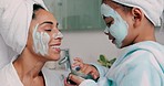 Family, facial and mask with mother in bathroom with young child using hand to apply cosmetics. Wellness, black family and face cosmetic pamper treatment with kid and mama in happy home.