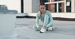 Fitness, workout and woman tie shoe before exercise outdoor on a rooftop in the city or New york. Female athlete prepare to start wellness training, sneakers or health cardio training in the morning