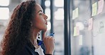 Business woman, thinking and planning schedule for strategy, brainstorming or tasks at office. Female employee designer contemplating project idea, writing or sticky note on glass window at workplace