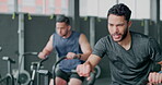 Exercise bike, workout and sweating with a man athlete in a gym for cardiovascular fitness. Elliptical machine, exercise and breathing with a male cycling to increase health, cardio or endurance