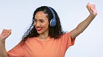 Headphones, dance and happy woman with music in a studio moving for a celebration or party. Happiness, smile and excited female model dancing to a playlist, album or song isolated by white background