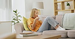 Relax, coffee and phone with woman on sofa for break, browsing and social media. Technology, internet and happy with girl scrolling online in living room at home for message, calm and website