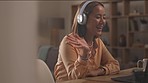 Laptop, headphones and woman on an online meeting at her home working space for remote job. Technology, computer and professional Asian female employee on virtual call in living room at her house.